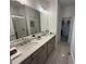 Bright bathroom featuring double vanity, stone countertop, modern fixtures, and glass enclosed shower at 3987 Allegretto Cir # 250, Atlanta, GA 30339