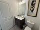 Bathroom with modern vanity, fixtures, framed mirror, and natural color scheme at 3987 Allegretto Cir # 250, Atlanta, GA 30339