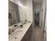 Modern bathroom featuring double sinks, a walk-in shower and tiled floors at 3987 Allegretto Cir # 250, Atlanta, GA 30339