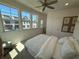 Bright bedroom featuring a ceiling fan and multiple windows for natural light and exterior views at 3987 Allegretto Cir # 250, Atlanta, GA 30339