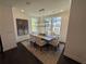 Bright dining room featuring a modern chandelier, dining table, and large windows at 3987 Allegretto Cir # 250, Atlanta, GA 30339