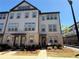 Attractive townhome features gray siding, brick accents, and a welcoming front entrance at 3987 Allegretto Cir # 250, Atlanta, GA 30339