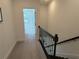 Upstairs hallway with black metal stair railing and neutral carpet at 3987 Allegretto Cir # 250, Atlanta, GA 30339