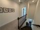 Hallway with carpeted floor and dark wood railings leading to bedrooms at 3987 Allegretto Cir # 250, Atlanta, GA 30339