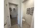 View of hallway to walk-in closet and powder room with stylish tile flooring and neutral paint at 3987 Allegretto Cir # 250, Atlanta, GA 30339