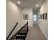 Hallway with carpeted floor and dark wood railings leading to bedrooms at 3987 Allegretto Cir # 250, Atlanta, GA 30339