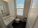 Cozy powder room with pedestal sink, neutral colors and modern fixtures at 3987 Allegretto Cir # 250, Atlanta, GA 30339