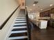 Staircase leading to the kitchen with hardwood floors and white accents at 3987 Allegretto Cir # 250, Atlanta, GA 30339