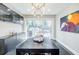 Modern dining room featuring a contemporary light fixture, large sliding glass doors, and sleek cabinetry at 727 Cool Hollow Dr, Decatur, GA 30033