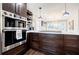 Modern kitchen boasting stainless steel appliances, dark wood cabinets, and sleek pendant lighting at 727 Cool Hollow Dr, Decatur, GA 30033