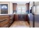 Charming kitchen with rich wood cabinetry, stainless steel appliances, and a bright window over the sink at 727 Cool Hollow Dr, Decatur, GA 30033