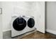 Modern laundry room with front-loading washer and dryer, and ample storage at 727 Cool Hollow Dr, Decatur, GA 30033