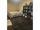 Bedroom featuring a comfortable bed, adjacent to a large shelving unit for storage and decor at 123 Spring St, Stockbridge, GA 30281