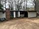 Single story home with a brick chimney and an open porch area; the yard is dirt at 123 Spring St, Stockbridge, GA 30281