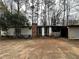Charming single-story home with a brick chimney and ample front yard space and several bicycles at 123 Spring St, Stockbridge, GA 30281