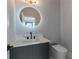 Powder room featuring a modern round LED mirror and sleek fixtures at 1653 Wayland Ne Cir, Brookhaven, GA 30319