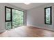 Bedroom with hardwood floors and multiple windows providing a bright and open space at 1653 Wayland Ne Cir, Brookhaven, GA 30319