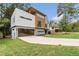 Modern home showcasing clean lines, large driveway, and contemporary design with a well-maintained front lawn at 1653 Wayland Ne Cir, Brookhaven, GA 30319