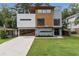 Striking contemporary home featuring a unique two-tone design and a beautifully manicured front lawn at 1653 Wayland Ne Cir, Brookhaven, GA 30319