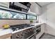 Modern kitchen with stainless steel appliances, sleek countertops, and a large window offering scenic neighborhood views at 1653 Wayland Ne Cir, Brookhaven, GA 30319