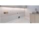 Laundry room with a cabinet and sink, featuring tile floors and neutral walls at 1653 Wayland Ne Cir, Brookhaven, GA 30319