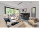 Inviting living room with stylish furniture, a modern fireplace, and large glass doors opening to the outdoors at 1653 Wayland Ne Cir, Brookhaven, GA 30319