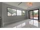 Living room with large windows, marble floors and sliding doors to a balcony at 1653 Wayland Ne Cir, Brookhaven, GA 30319