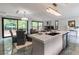 Elegant living space with a chef's kitchen featuring a marble island and open views to a dining and living area at 1653 Wayland Ne Cir, Brookhaven, GA 30319