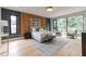 Bright main bedroom with a wood accent wall, large windows, and a seating area at 1653 Wayland Ne Cir, Brookhaven, GA 30319