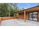 Covered outdoor patio perfect for entertaining with stone pavers and wooded view at 1653 Wayland Ne Cir, Brookhaven, GA 30319