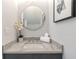 Stylish powder room with marble countertop, round mirror, and modern decor at 1653 Wayland Ne Cir, Brookhaven, GA 30319