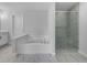 Relaxing bathroom featuring a soaking tub, glass-enclosed shower, and modern fixtures at 3624 Silvery Way, Powder Springs, GA 30127