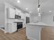 Modern kitchen featuring white cabinets, stainless steel appliances, and a spacious island at 3624 Silvery Way, Powder Springs, GA 30127