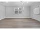 Bright living room with modern chandelier and wood-look flooring at 3624 Silvery Way, Powder Springs, GA 30127