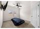 Cozy bedroom with neutral carpet, ceiling fan, and bright natural light from the window at 3696 Lower Burris Rd, Canton, GA 30114