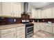 A well-appointed kitchen with stainless steel appliances and light-colored cabinets at 3696 Lower Burris Rd, Canton, GA 30114