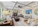 Spacious living room with coffered ceiling, stone fireplace, and ample natural light at 5365 Vendelay Ln, Cumming, GA 30040