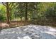 Backyard with gravel, stepping stones, and metal fence with a natural and wooded backdrop at 1323 Peachtree Ne Vw, Atlanta, GA 30319