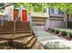 Inviting townhome exterior featuring brick steps, metal railings, garage, and colorful doors at 1323 Peachtree Ne Vw, Atlanta, GA 30319