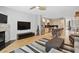 Open-concept living room and kitchen featuring hardwood floors and a brick fireplace at 1323 Peachtree Ne Vw, Atlanta, GA 30319