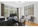 Modern home office with hardwood floors, large window, and stylish brick accent wall at 1323 Peachtree Ne Vw, Atlanta, GA 30319