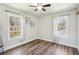 This bedroom features hardwood floors, a ceiling fan, and bright, natural light at 1521 Dianne Se Ct, Atlanta, GA 30316