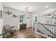 Open hallway features chair, cabinet and wall art along with natural light from the window at 1521 Dianne Se Ct, Atlanta, GA 30316