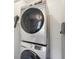 Modern laundry room featuring a stacked washer and dryer at 1521 Dianne Se Ct, Atlanta, GA 30316