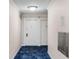 Hallway featuring neutral walls, blue carpet flooring and two doors leading to the unit at 300 Peachtree St # 23-A, Atlanta, GA 30308