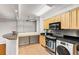 Bright kitchen featuring stone countertops, stainless appliances, and eat in bar at 300 Peachtree St # 23-A, Atlanta, GA 30308