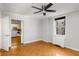 Bright bedroom featuring a modern ceiling fan, window view, and doorway to the kitchen at 300 Peachtree St # 23-A, Atlanta, GA 30308