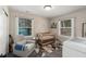 Cozy Bedroom featuring a crib, comfortable rocking chair, geometric rug, and plenty of natural light at 3430 Pinehill Dr, Decatur, GA 30032