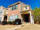 Charming townhome featuring brick facade and a welcoming covered front porch at 5070 Oakley Commons Blvd, Union City, GA 30291