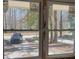 Double-paned windows offer a clear view of the wooded property at 5393 Booker T Dr, Morrow, GA 30260